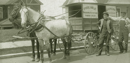 J.A. Pilling and assistant in front of Pilling's Dairy delivery wagon, circa 1915